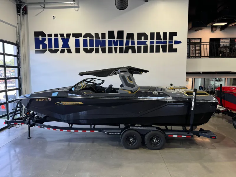 Slide: The Image of 2024 Nautique Super Air Nautique G25 Paragon boat displayed at Buxton Marine showroom. - 1