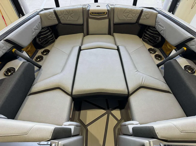 Slide: The Image of 2024 Nautique Super Air Nautique G25 Paragon interior with luxurious seating and cup holders. - 17