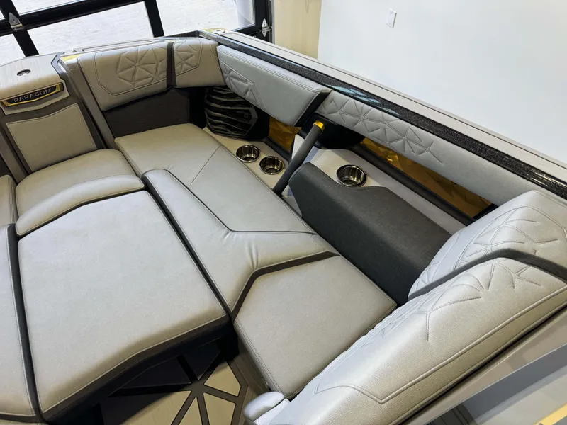 Slide: The Image of 2024 Nautique Super Air Nautique G25 Paragon interior with luxurious seating and cup holders. - 18