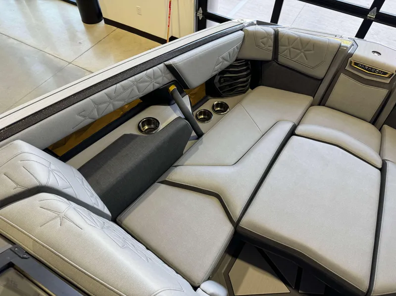 Slide: The Image of 2024 Nautique Super Air Nautique G25 Paragon interior with luxurious seating and cup holders. - 19