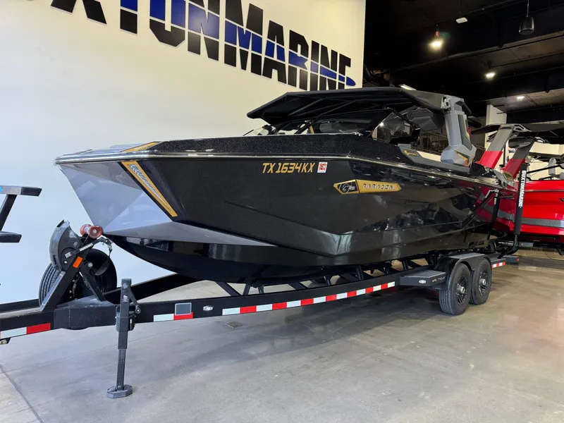 Slide: The Image of 2024 Nautique Super Air Nautique G25 Paragon boat on trailer in showroom. - 2