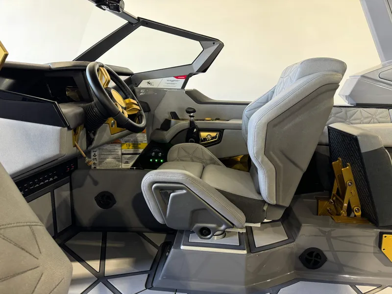 Slide: The Image of 2024 Nautique Super Air Nautique G25 Paragon interior with modern steering and luxurious seating. - 23