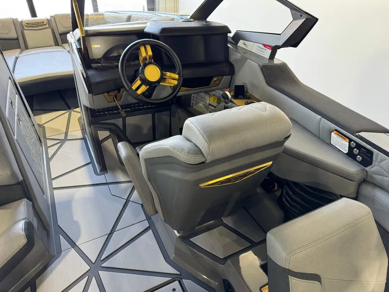 Slide: The Image of 2024 Nautique Super Air Nautique G25 Paragon interior with modern steering and seating. - 24