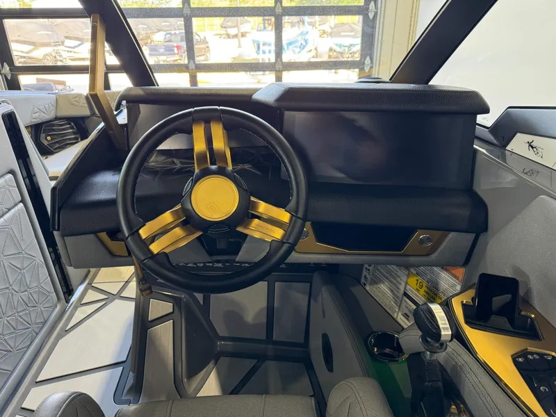 Slide: The Image of 2024 Nautique Super Air Nautique G25 Paragon cockpit with sleek steering wheel and modern dashboard. - 26