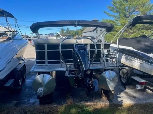 Slide: The Image of 2023 Starcraft EX 20C pontoon boat with outboard motor, parked on a trailer. - 4