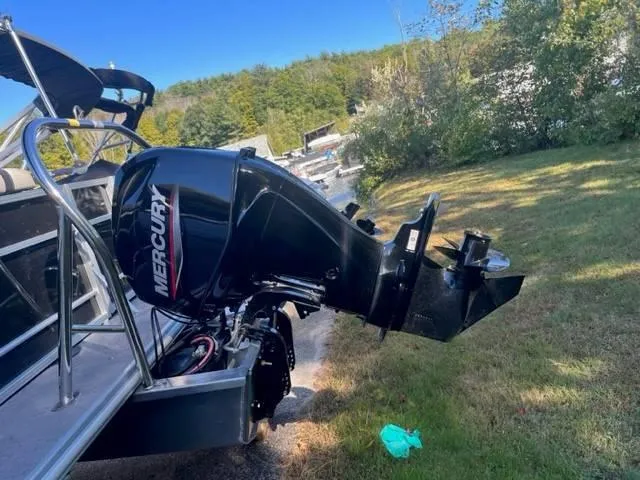 Slide: The Image of 2023 Starcraft EX 20C boat with Mercury outboard motor on grassy area. - 6