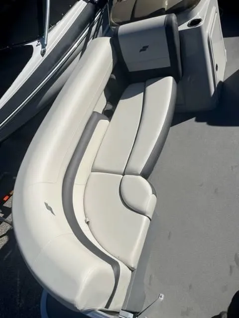 Slide: The Image of 2023 Starcraft EX 20C boat interior with curved seating and modern design. - 8