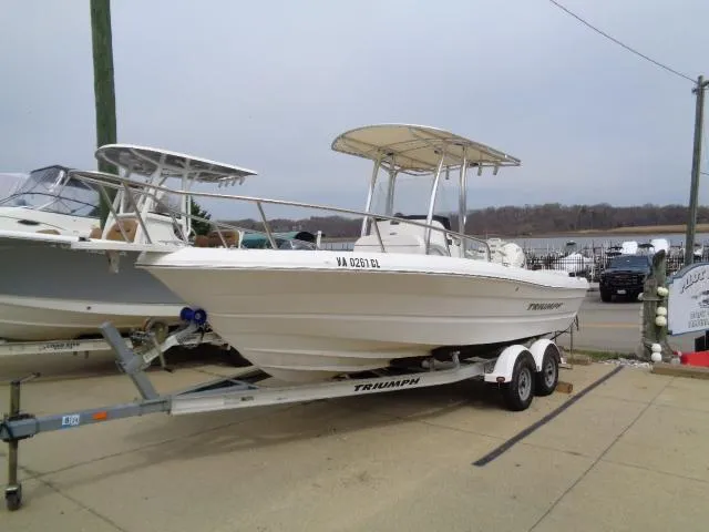 Slide: The Image of 2008 Triumph 215 CC boat on trailer, parked outdoors. - 1