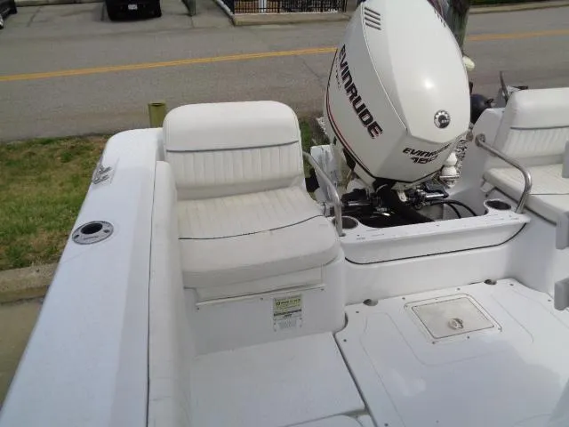 Slide: The Image of 2008 Triumph 215 CC boat with Evinrude motor, featuring white seating and deck. - 12