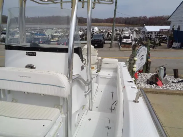 Slide: The Image of 2008 Triumph 215 CC boat docked at marina, featuring white seating and center console. - 14