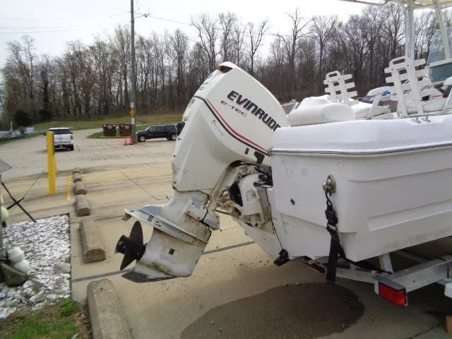 Slide: The Image of 2008 Triumph 215 CC boat with Evinrude outboard motor, parked on a trailer. - 4
