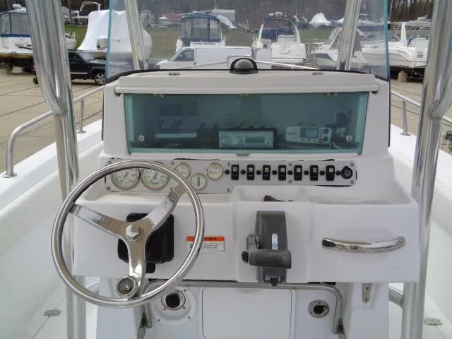 Slide: The Image of 2008 Triumph 215 CC boat dashboard with steering wheel and control panel. - 6