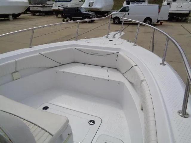 Slide: The Image of 2008 Triumph 215 CC boat with spacious seating and stainless steel railings. - 8