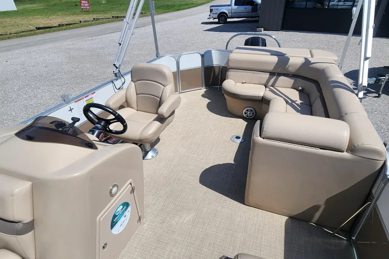 Slide: The Image of Interior of a 2018 Berkshire 22CL CTS pontoon boat with beige seating and steering console. - 5