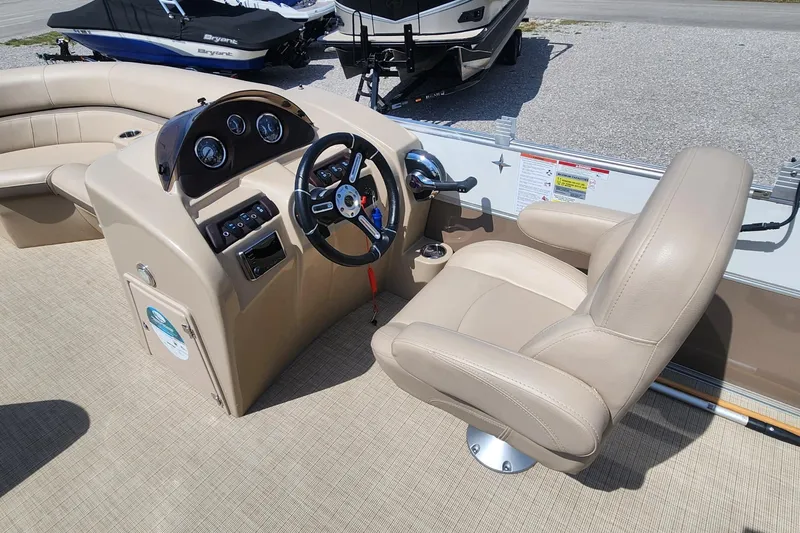 Slide: The Image of 2018 Berkshire 22CL CTS boat interior with beige captain's chair and control panel. - 7