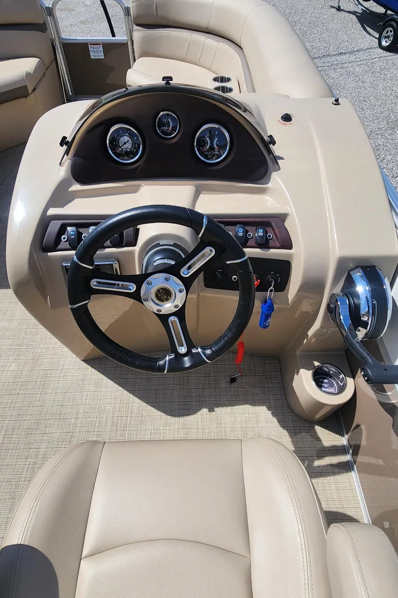 Slide: The Image of 2018 Berkshire 22CL CTS boat dashboard with steering wheel and gauges. - 8