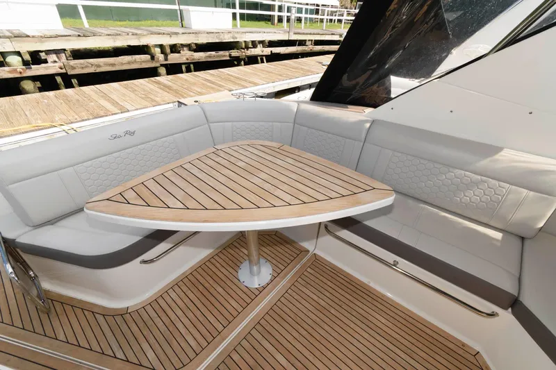 Slide: The Image of 2020 Sea Ray Sundancer 320 interior with elegant wood table and seating. - 11
