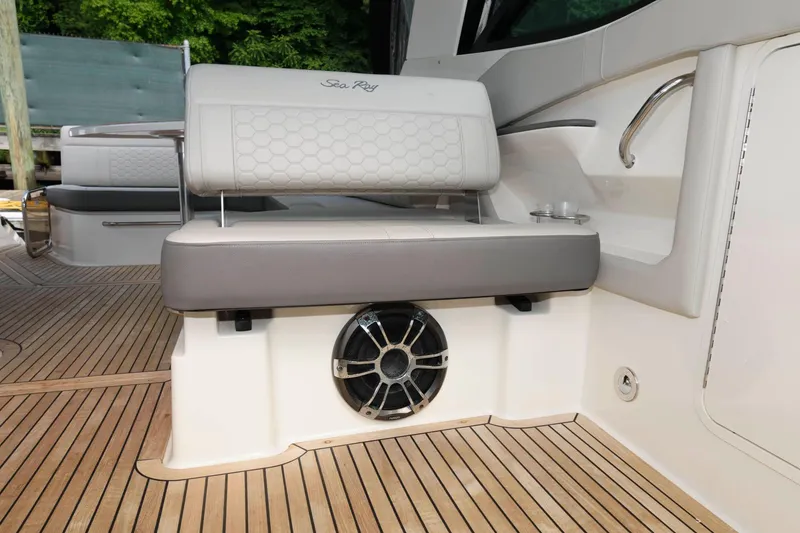 Slide: The Image of 2020 Sea Ray Sundancer 320 boat seating area with speaker on teak deck. - 13