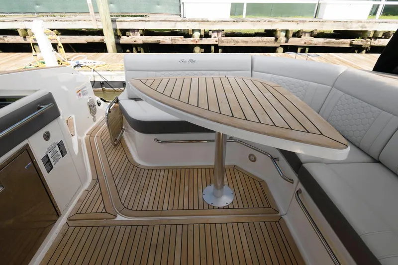 Slide: The Image of 2020 Sea Ray Sundancer 320 interior with elegant wooden table and seating area. - 2