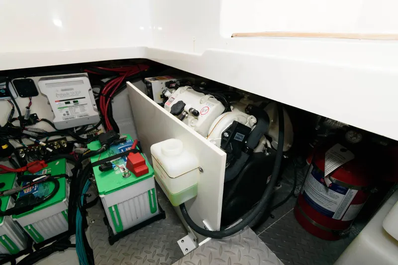 Slide: The Image of Engine compartment of 2020 Sea Ray Sundancer 320 with batteries and fire extinguisher. - 23