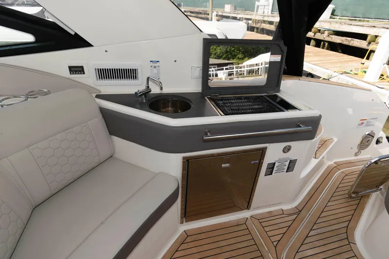 Slide: The Image of 2020 Sea Ray Sundancer 320 yacht interior with kitchenette, sink, and seating area. - 3