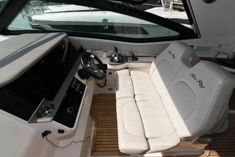 Slide: The Image of 2020 Sea Ray Sundancer 320 cockpit with white seating and modern controls. - 6
