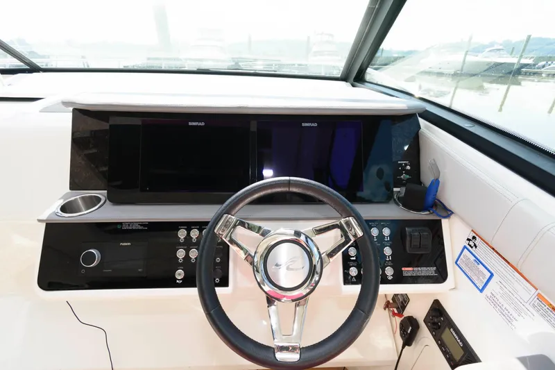 Slide: The Image of 2020 Sea Ray Sundancer 320 helm with modern controls and dual displays. - 7