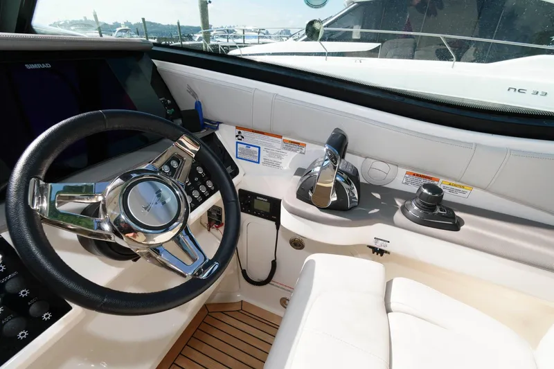 Slide: The Image of 2020 Sea Ray Sundancer 320 helm with steering wheel and controls, featuring modern design. - 8