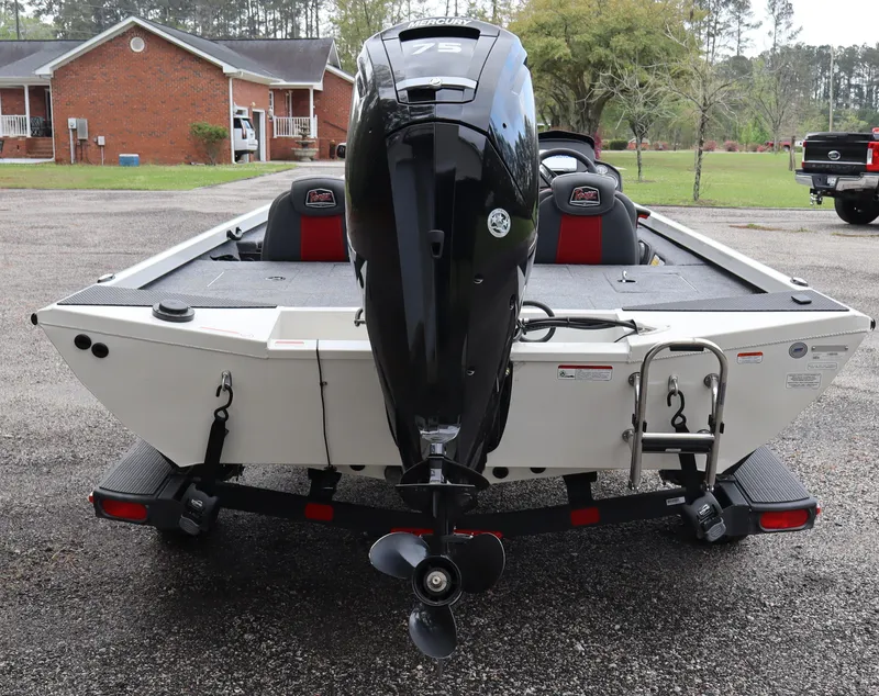 Slide: The Image of 2022 Ranger RT178 boat with powerful outboard motor, parked in residential area. - 2