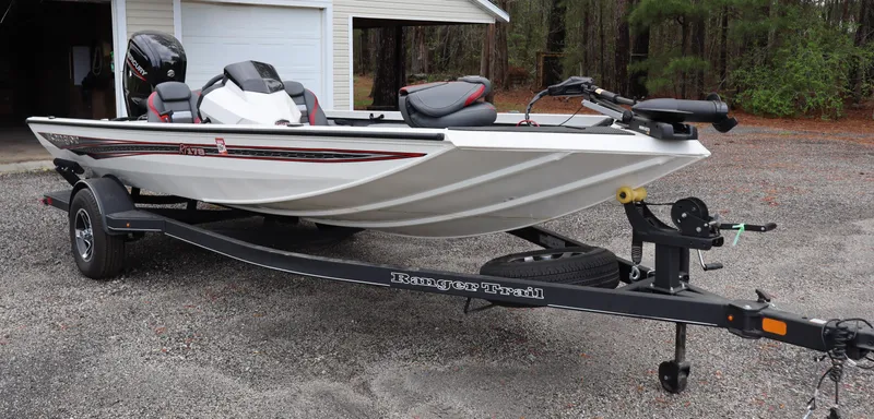 Slide: The Image of 2022 Ranger RT178 boat on trailer, parked outdoors near a garage. - 3