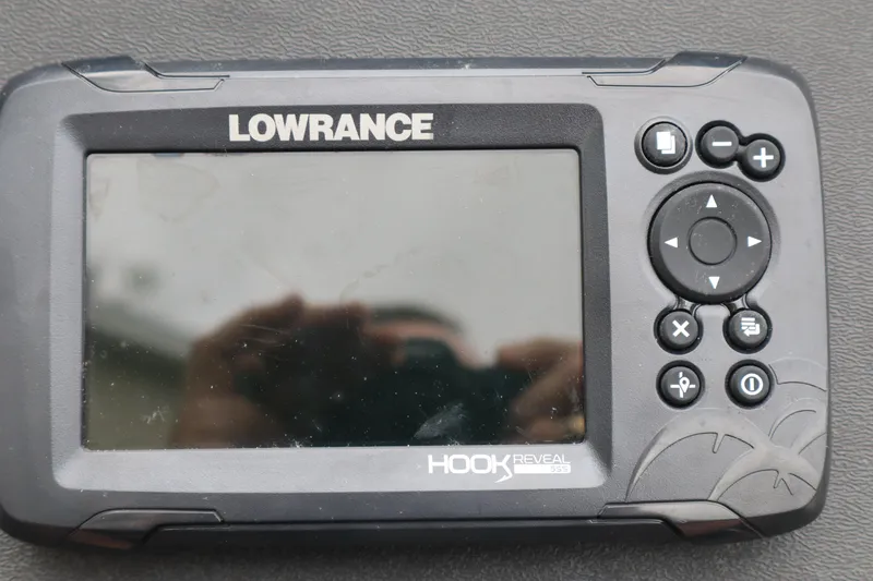 Slide: The Image of Lowrance Hook Reveal fish finder on Ranger RT178, 2022 model, with control buttons and display screen. - 7