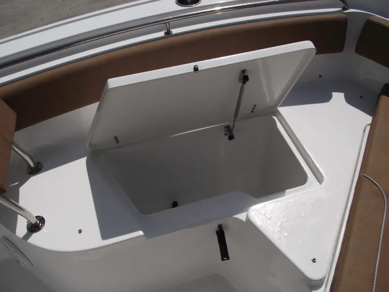 Slide: The Image of 2024 Sea Hunt Ultra 239 SE boat storage compartment with open lid, showcasing spacious interior. - 10