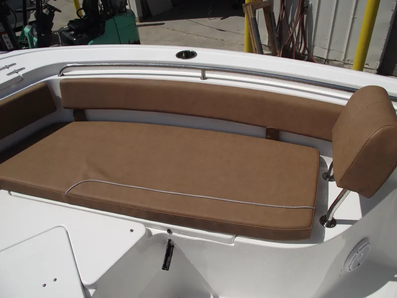 Slide: The Image of 2024 Sea Hunt Ultra 239 SE boat with tan cushioned seating. - 11