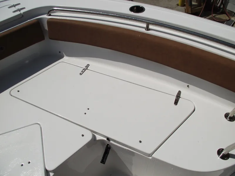 Slide: The Image of 2024 Sea Hunt Ultra 239 SE boat interior with storage compartment and seating. - 12