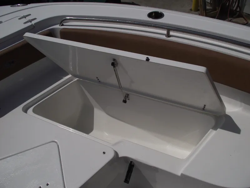 Slide: The Image of 2024 Sea Hunt Ultra 239 SE boat storage compartment open, showcasing spacious interior. - 13