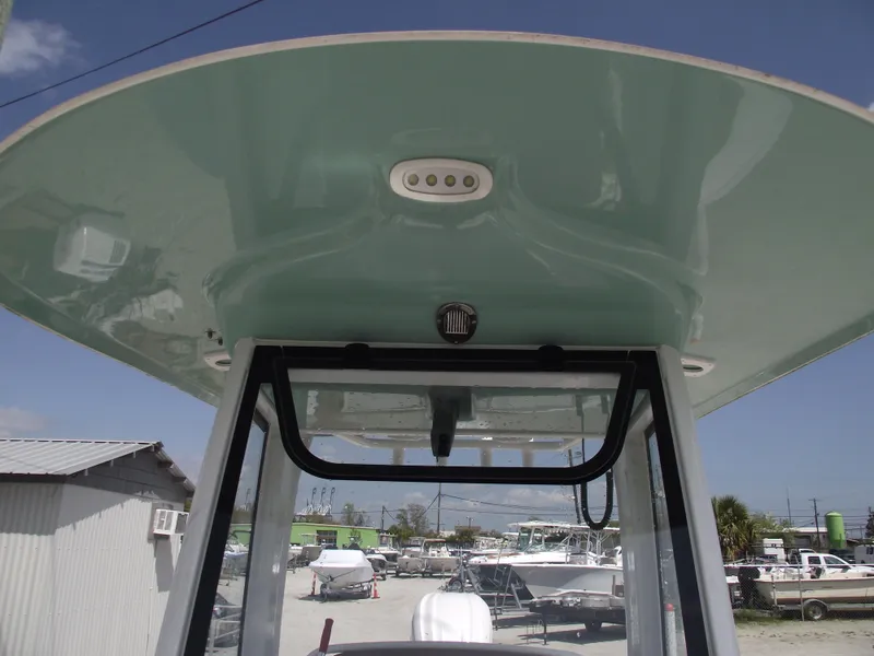 Slide: The Image of 2024 Sea Hunt Ultra 239 SE boat with sleek overhead console design. - 19