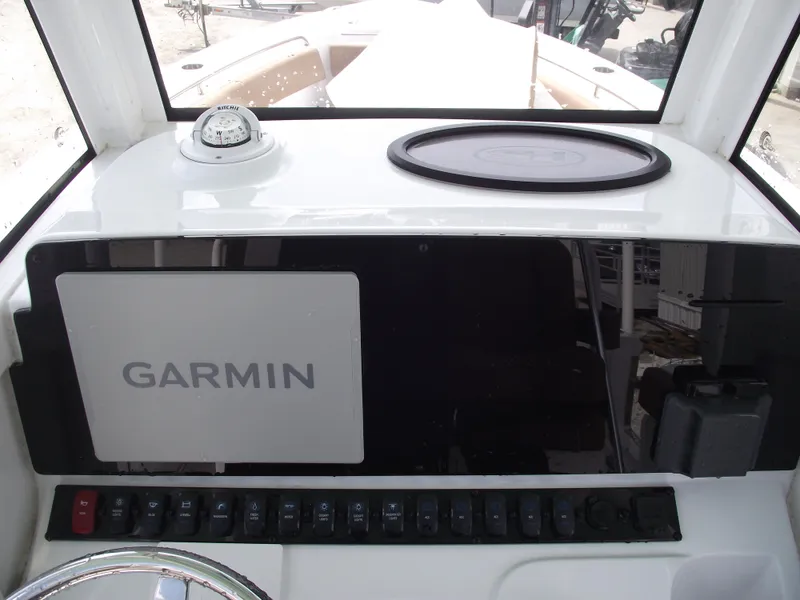 Slide: The Image of 2024 Sea Hunt Ultra 239 SE dashboard with Garmin navigation system. - 23