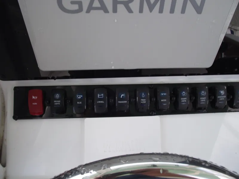 Slide: The Image of Control panel of 2024 Sea Hunt Ultra 239 SE boat with Garmin system. - 24