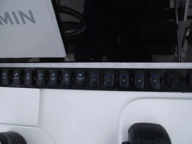 Slide: The Image of Control panel of 2024 Sea Hunt Ultra 239 SE boat with switches and Garmin display. - 25