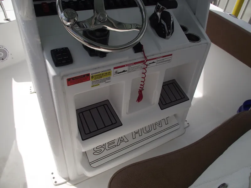 Slide: The Image of 2024 Sea Hunt Ultra 239 SE boat console with steering wheel and controls. - 27