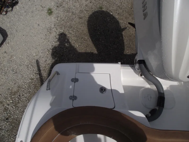 Slide: The Image of 2024 Sea Hunt Ultra 239 SE boat stern with engine and deck details. - 29