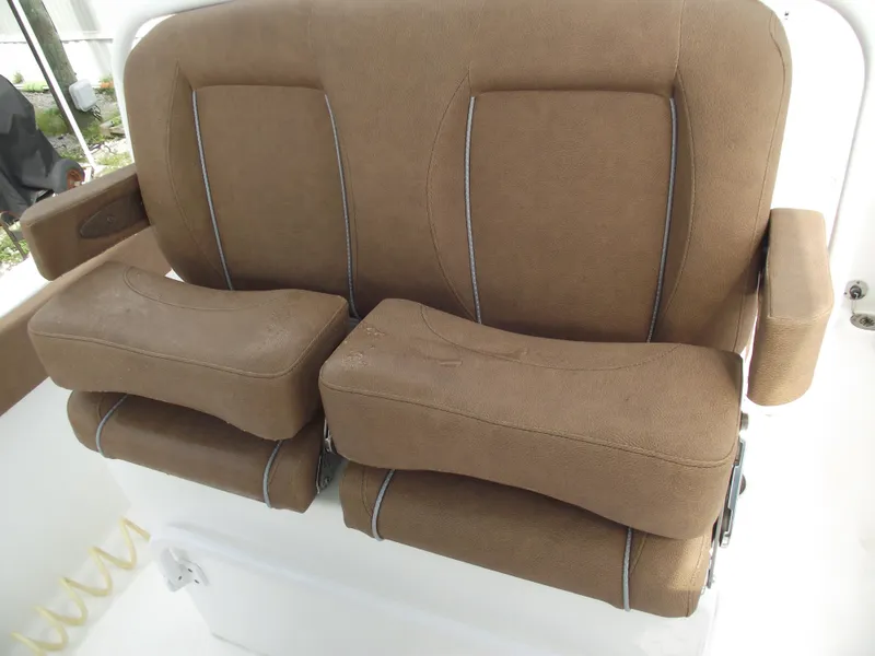 Slide: The Image of 2024 Sea Hunt Ultra 239 SE boat seats, brown upholstery, dual armrests. - 31