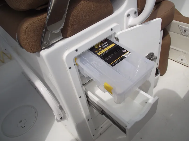 Slide: The Image of 2024 Sea Hunt Ultra 239 SE boat storage compartment with tackle box. - 35