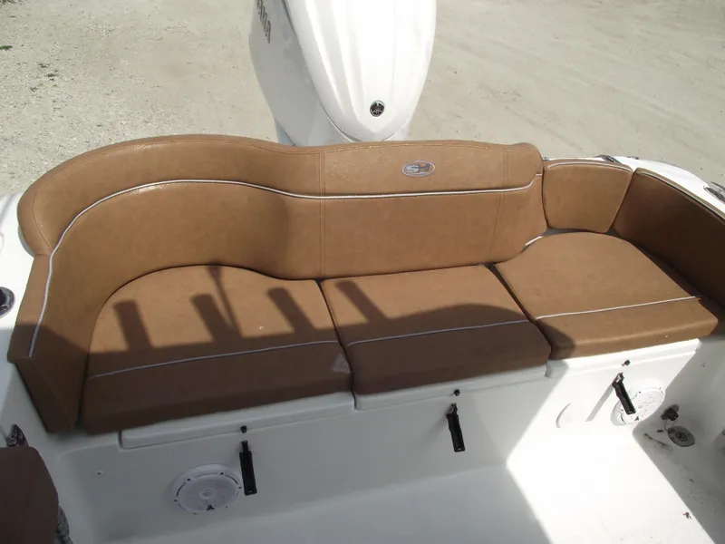 Slide: The Image of 2024 Sea Hunt Ultra 239 SE boat with brown cushioned seating. - 39
