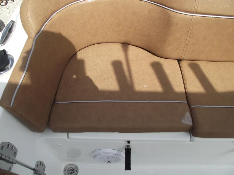 Slide: The Image of 2024 Sea Hunt Ultra 239 SE boat seat with brown upholstery and white stitching. - 40