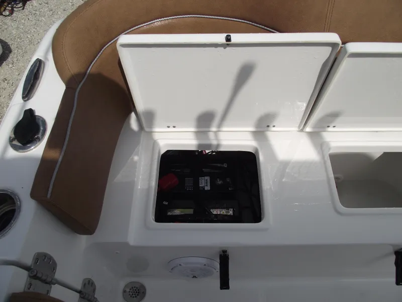 Slide: The Image of 2024 Sea Hunt Ultra 239 SE boat battery compartment with open hatch. - 42