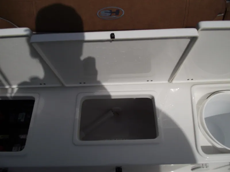 Slide: The Image of 2024 Sea Hunt Ultra 239 SE boat storage compartments with open lids. - 45