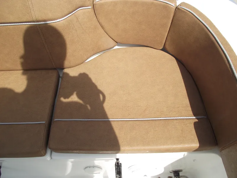 Slide: The Image of 2024 Sea Hunt Ultra 239 SE boat seating with brown cushions and white piping. - 46