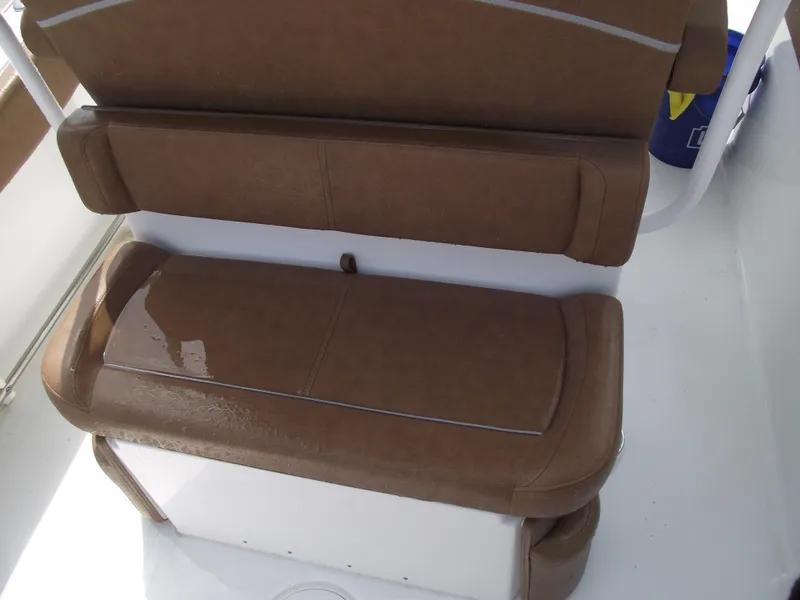 Slide: The Image of 2024 Sea Hunt Ultra 239 SE boat seating with brown cushions. - 49