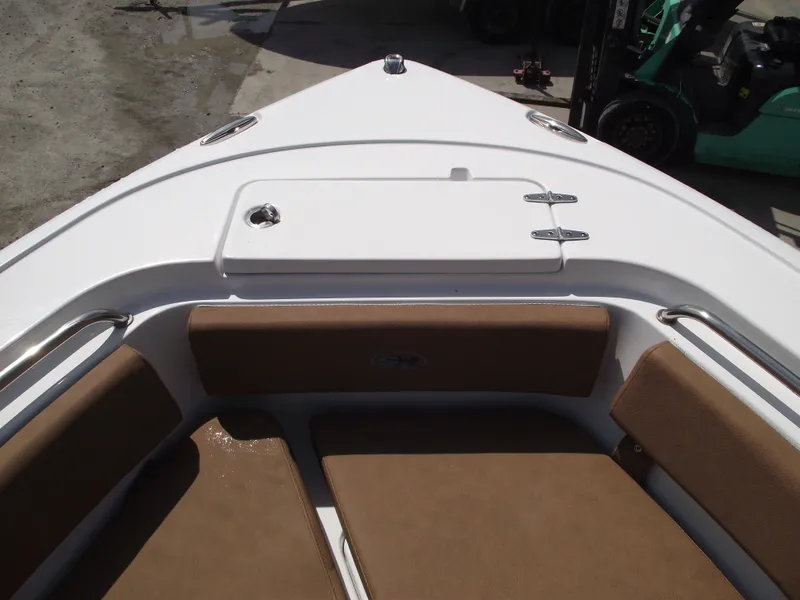 Slide: The Image of 2024 Sea Hunt Ultra 239 SE boat interior with cushioned seating and storage compartment. - 5